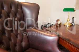 Arm chair with telephone, alarm clock and lamp on table