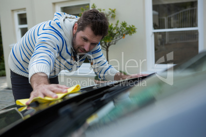 Auto service staff cleaning a car with duster