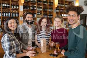 Friends having glass of beer in bar