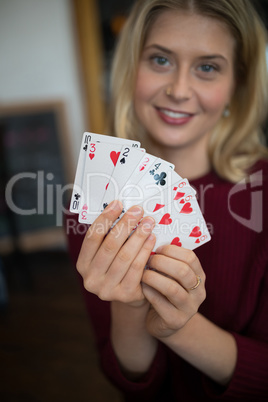 Beautiful woman showing cards in bar Beautiful woman showing cards in bar