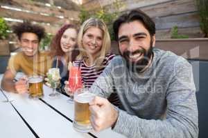 Friends holding glass of drinks in bar