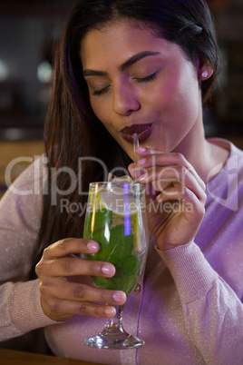 Woman sipping on a drink