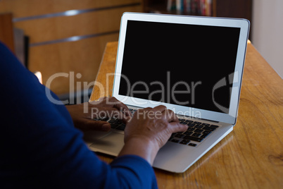 Waitress using laptop in cafe