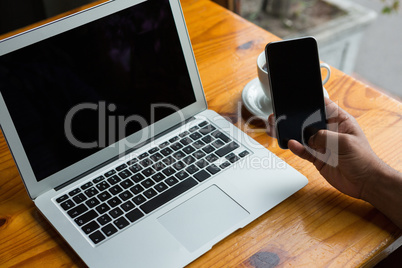 Man using mobile phone in cafÃ?Â©