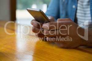 Man using mobile phone in cafÃ?Â©