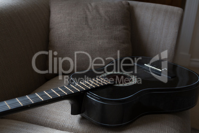 Guitar kept on sofa in living room