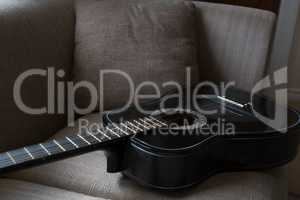 Guitar kept on sofa in living room