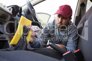 Auto service staff cleaning car interior