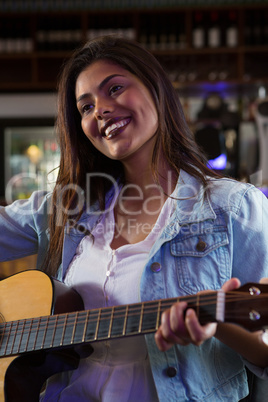 Woman playing guitar