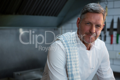 Male chef sitting in commercial kitchen
