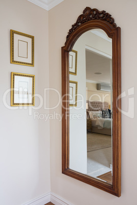 Wooden framed mirror on wall