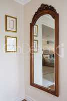 Wooden framed mirror on wall