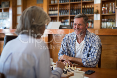 Friends playing chess in bar