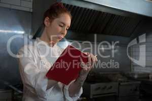 Female chef taking down an order in the book