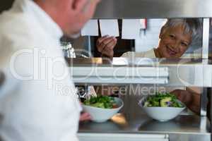 Male and female chef interacting with each other