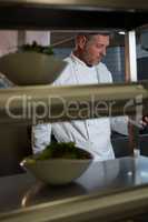 Male chef using mobilephone