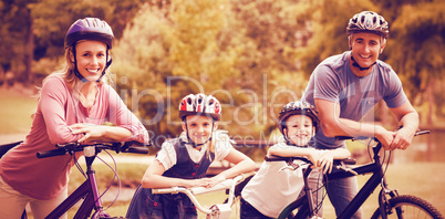 Happy family on bicycle at park