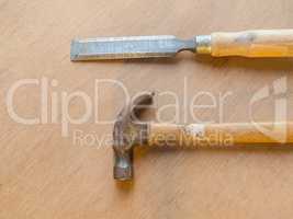 Hammer and chisel on wooden table background