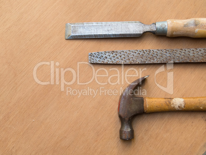 Hammer, rasp and chisel for carpentry, on wooden table