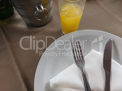 Table with plate and cutlery on napkin