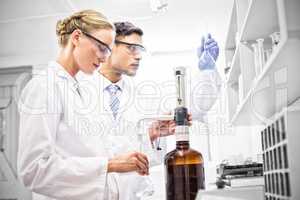 Scientists working attentively with beaker