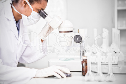 Scientist working on microscope