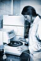 Focused scientist using a centrifuge