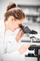 Scientist working on microscope