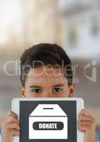 Boy holding tablet with donate box icon for charity