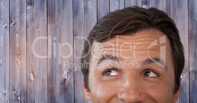 Man looking up with wood background