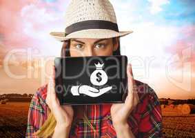 Woman holding tablet with hand giving money bag icon
