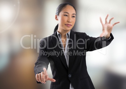 Businesswoman touching air in front of blurred background