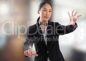 Businesswoman touching air in front of blurred background