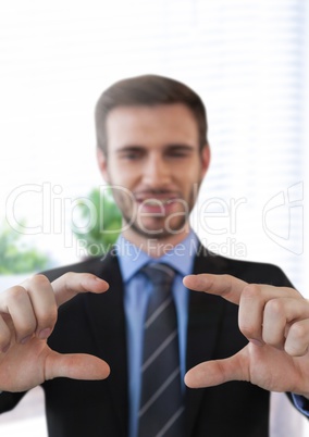 Businessman touching air in front of office window