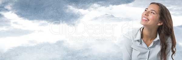 Woman looking up with cloudy sky background