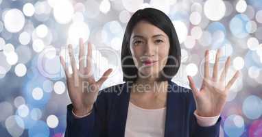 Businesswoman touching air in front of sparkles