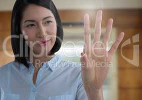 Businesswoman touching air in front of elevator