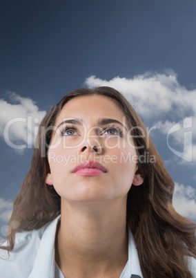 Woman looking up with cloudy background