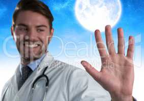 Doctor man touching air in front of moon