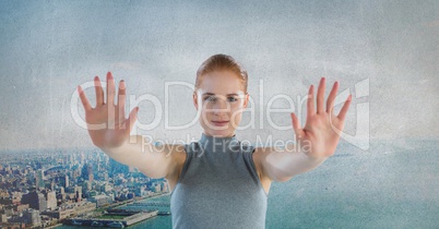 Futuristic Businesswoman touching air in front of grey grunge city