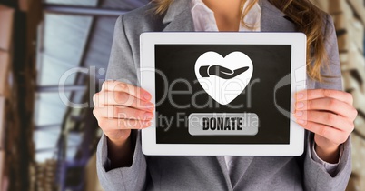 Woman holding tablet with donate button and hand giving with heart for charity