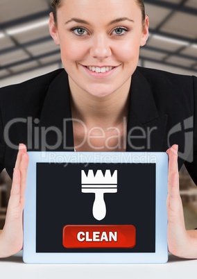 Woman holding tablet with clean button and brush icon