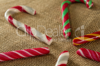 Multicolored candy canes arranged on fabric