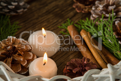 High angle view of pine cones with illuminated candles and wreath