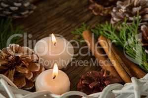 High angle view of pine cones with illuminated candles and wreath