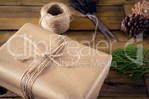 Fir, pine cone and wrapping materials on wooden table