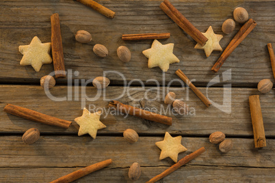 Star shape cookies and cinnamon sticks with walnuts