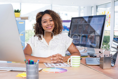 Portrait of female executive sitting at desk in office