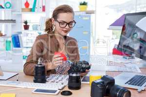 Female executive repairing a digital camera