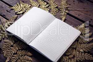Open book and christmas decoration on wooden plank